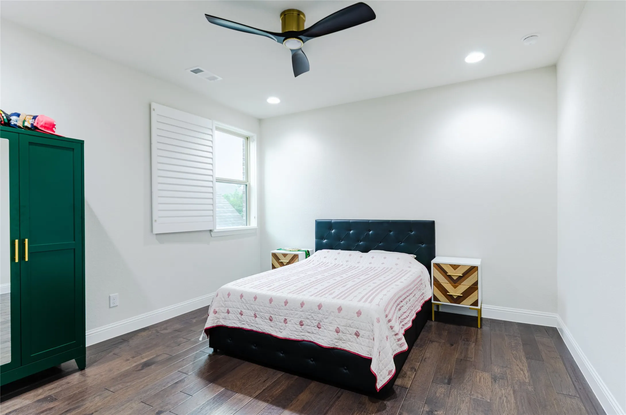Spacious room featuring wood-finish flooring, recessed lighting, and a contemporary ceiling fan