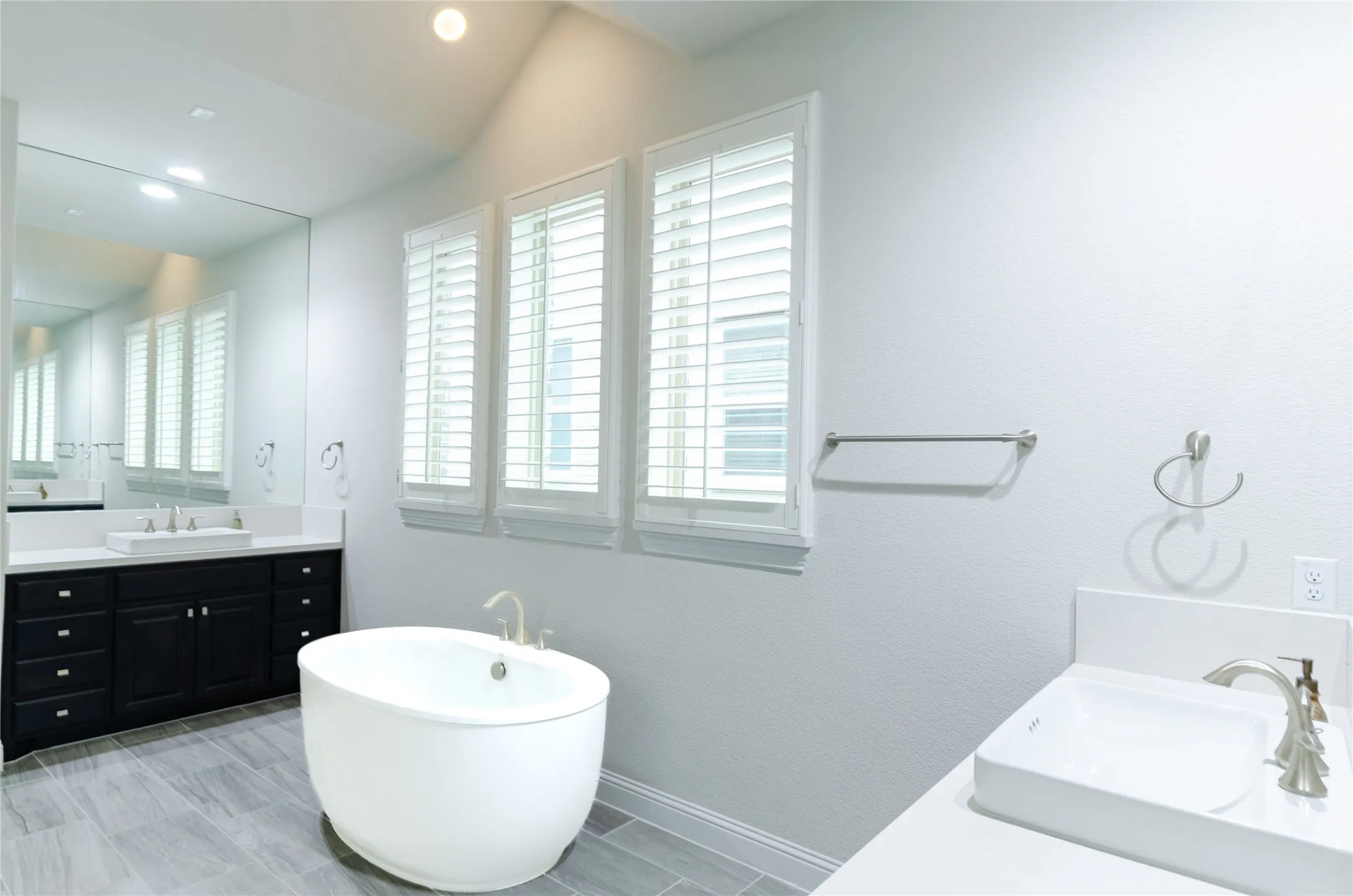 Freestanding soaking tub with a floor-mounted faucet