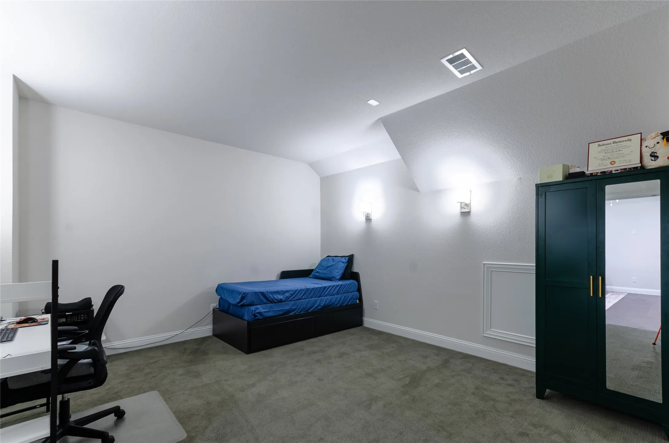 Media room carpeted room with sloped ceilings and recessed lighting