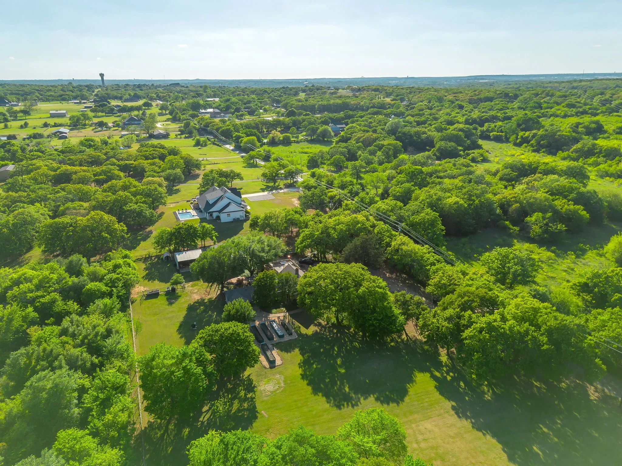 Truly special. Land of this quality - with fencing, raised garden beds, water storage, multiple outbuildings, and a one of a kind home...with all these TREES! Come see us!
