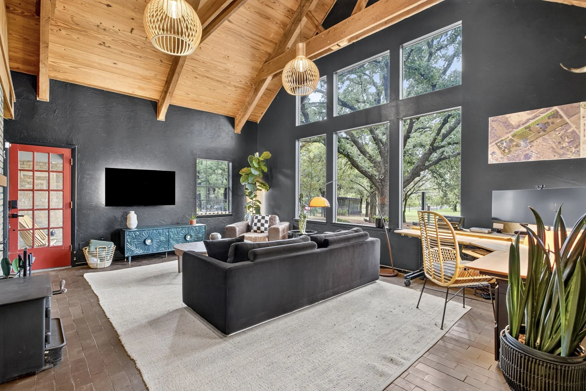 A stunning family room: bold paint, new lighting, exquisite vaulted ceiling with exposed beams...and those views.