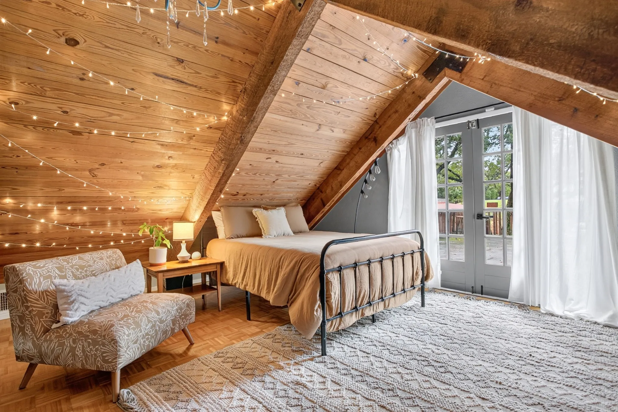 Who here loves a loft? Especially one as DREAMY as this. Built-ins on the opposite wall. Swoon-worthy parquet floors. French doors lead to a huge balcony-deck area over the covered patio and parking.
