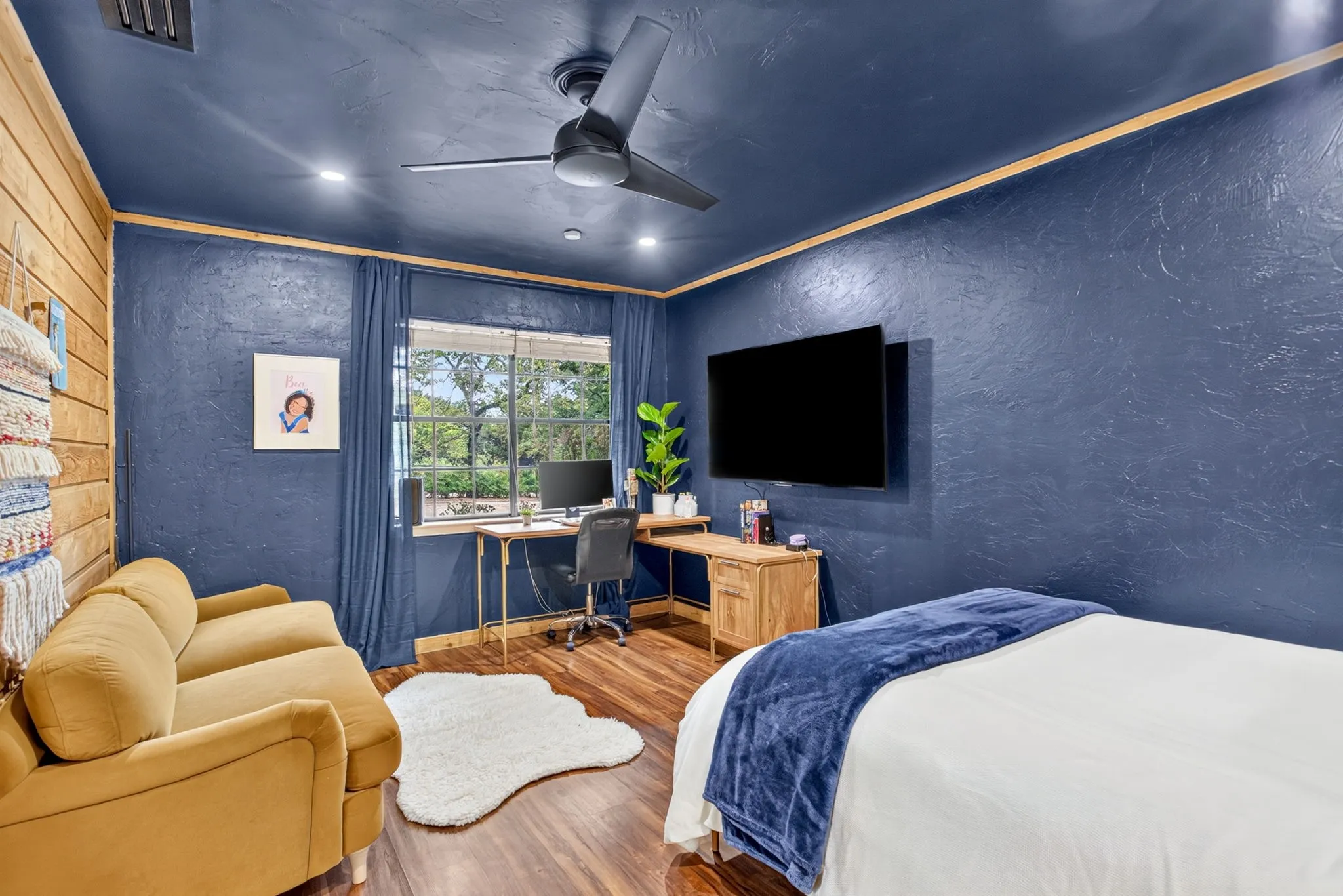 Stunning secondary bedroom with custom storage cabinets, fresh paint and lighting.