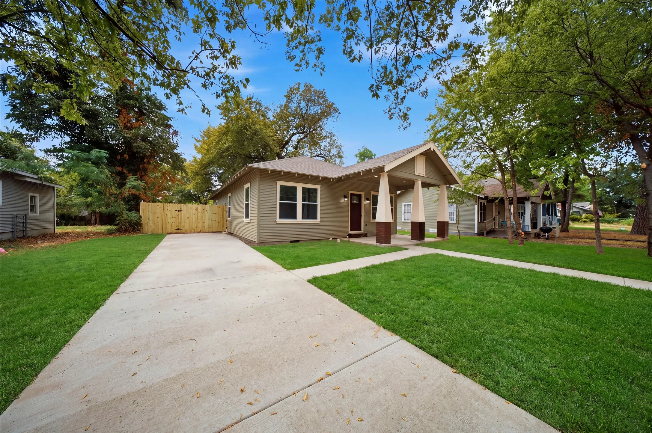 Exterior featuring a covered entry, concrete driveway, and front walkway