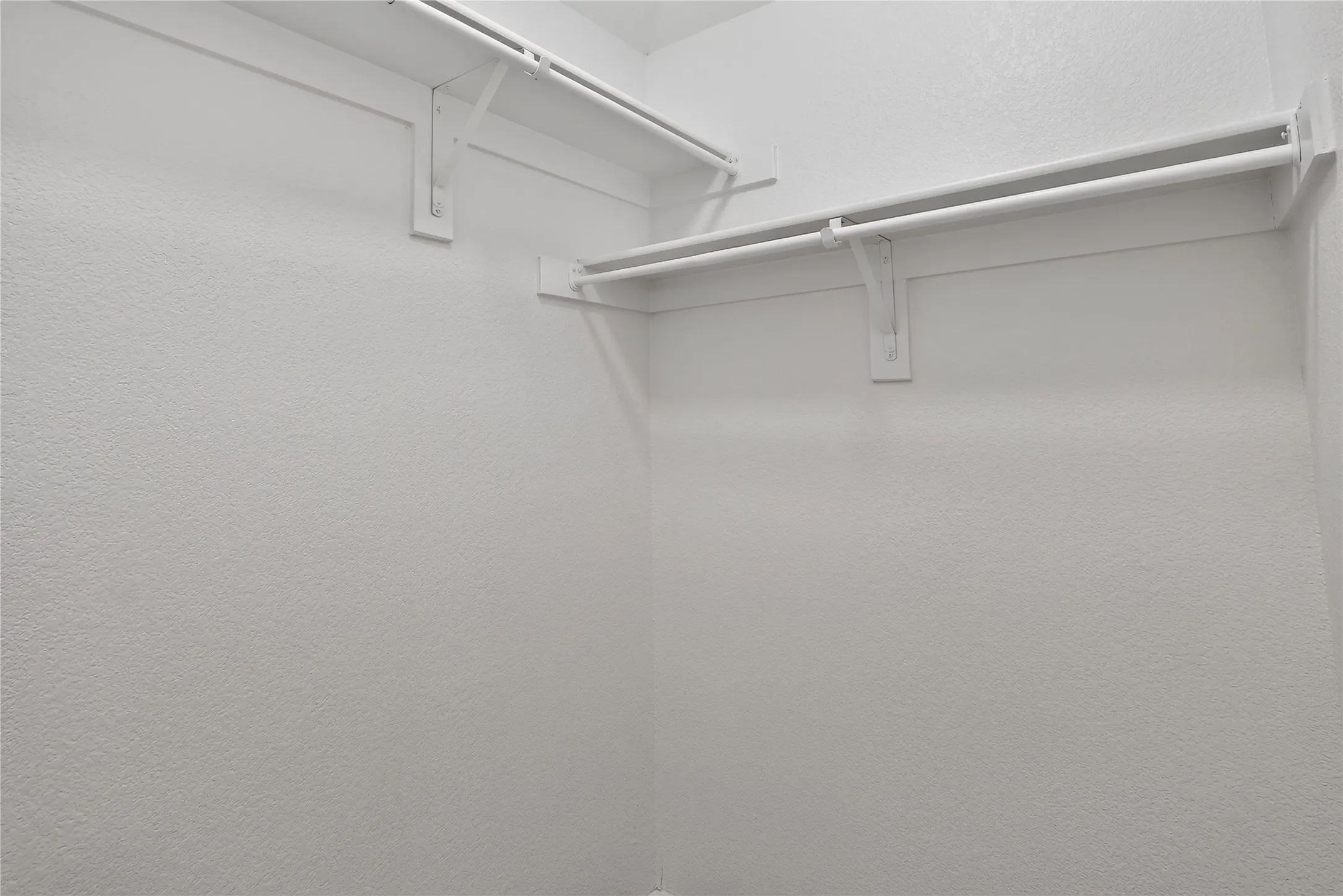 White shelving with hanging rods