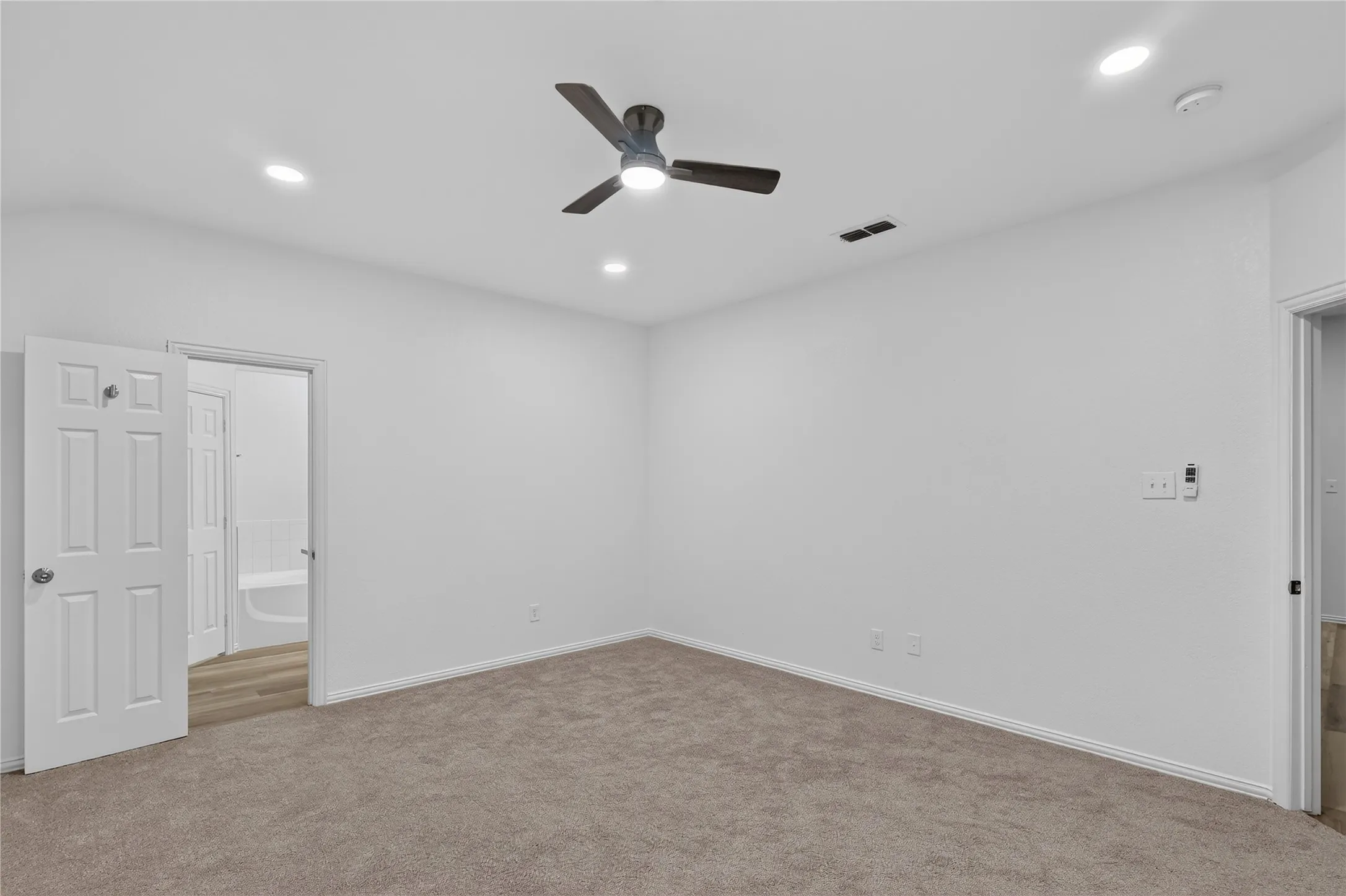 Recessed lighting, ceiling fan, and carpeted flooring