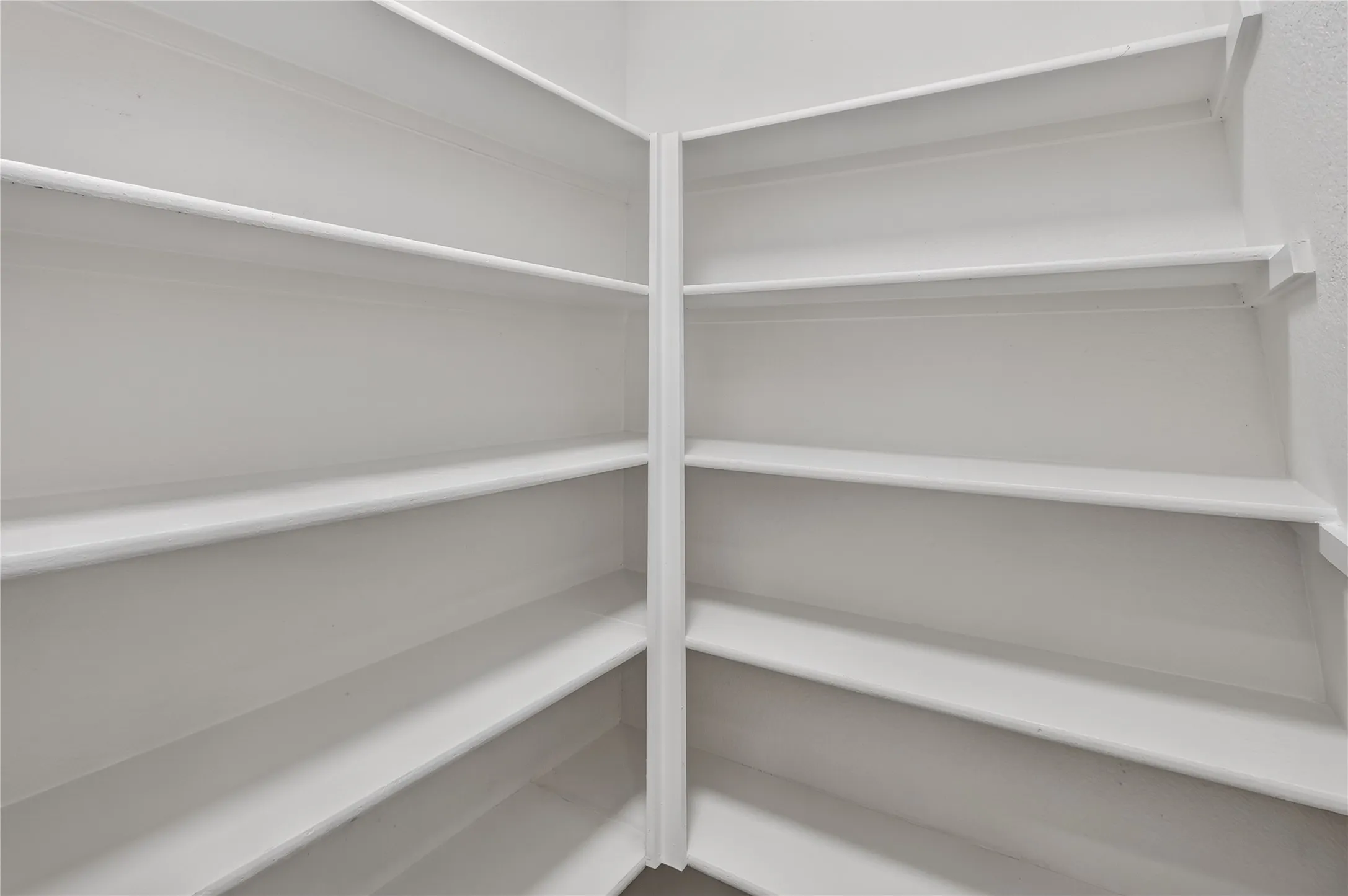 Built-in corner shelving with a light finish