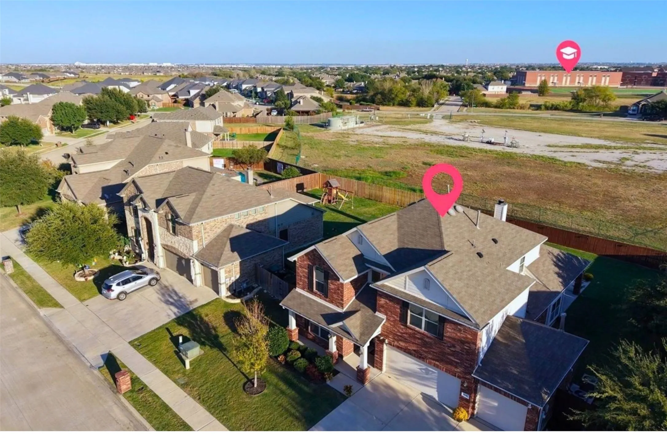 Brick and stone exterior residence with an attached two-car garage, concrete driveway, and front yard landscaping