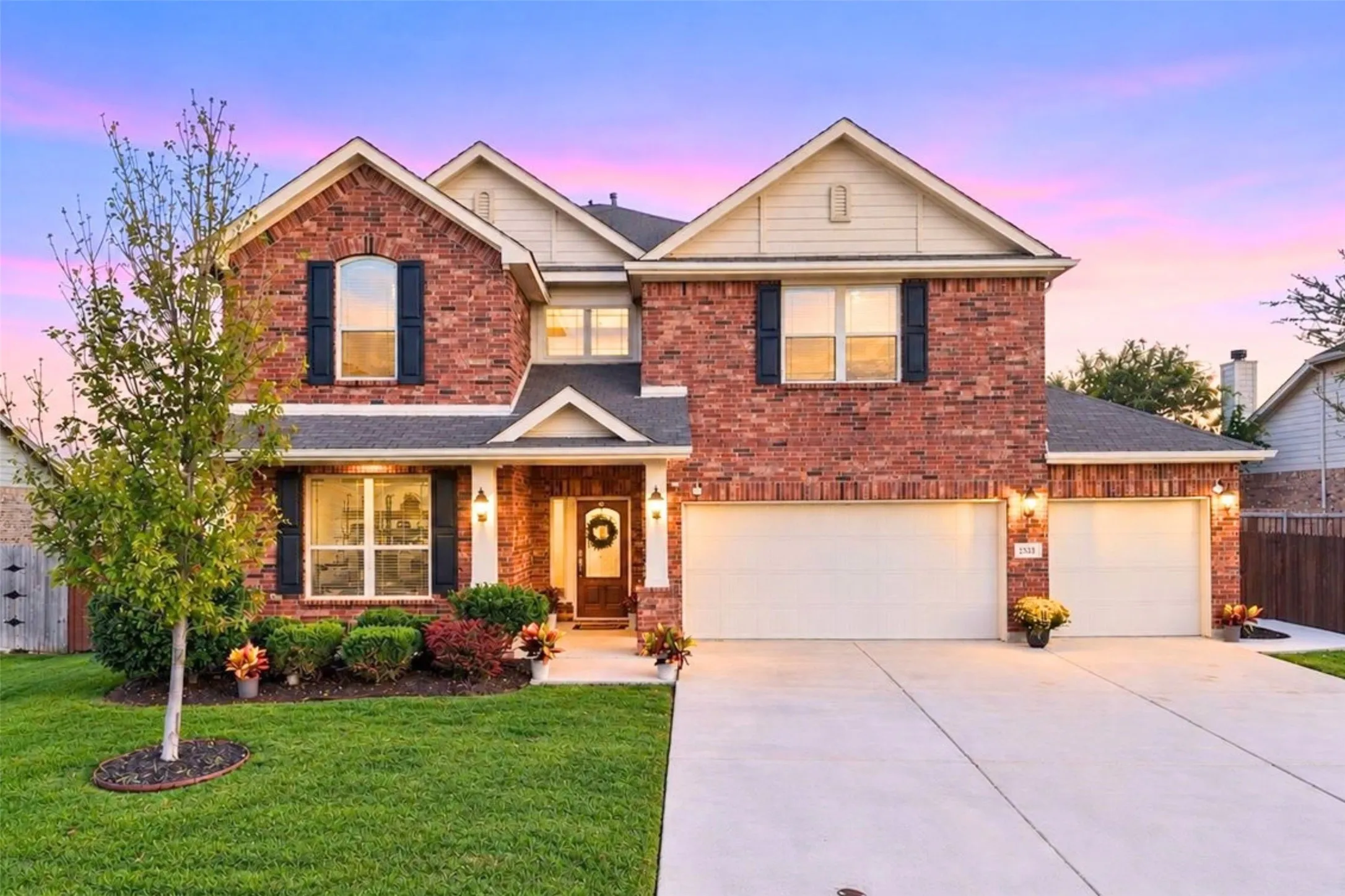 Two-story brick exterior with gabled roofline