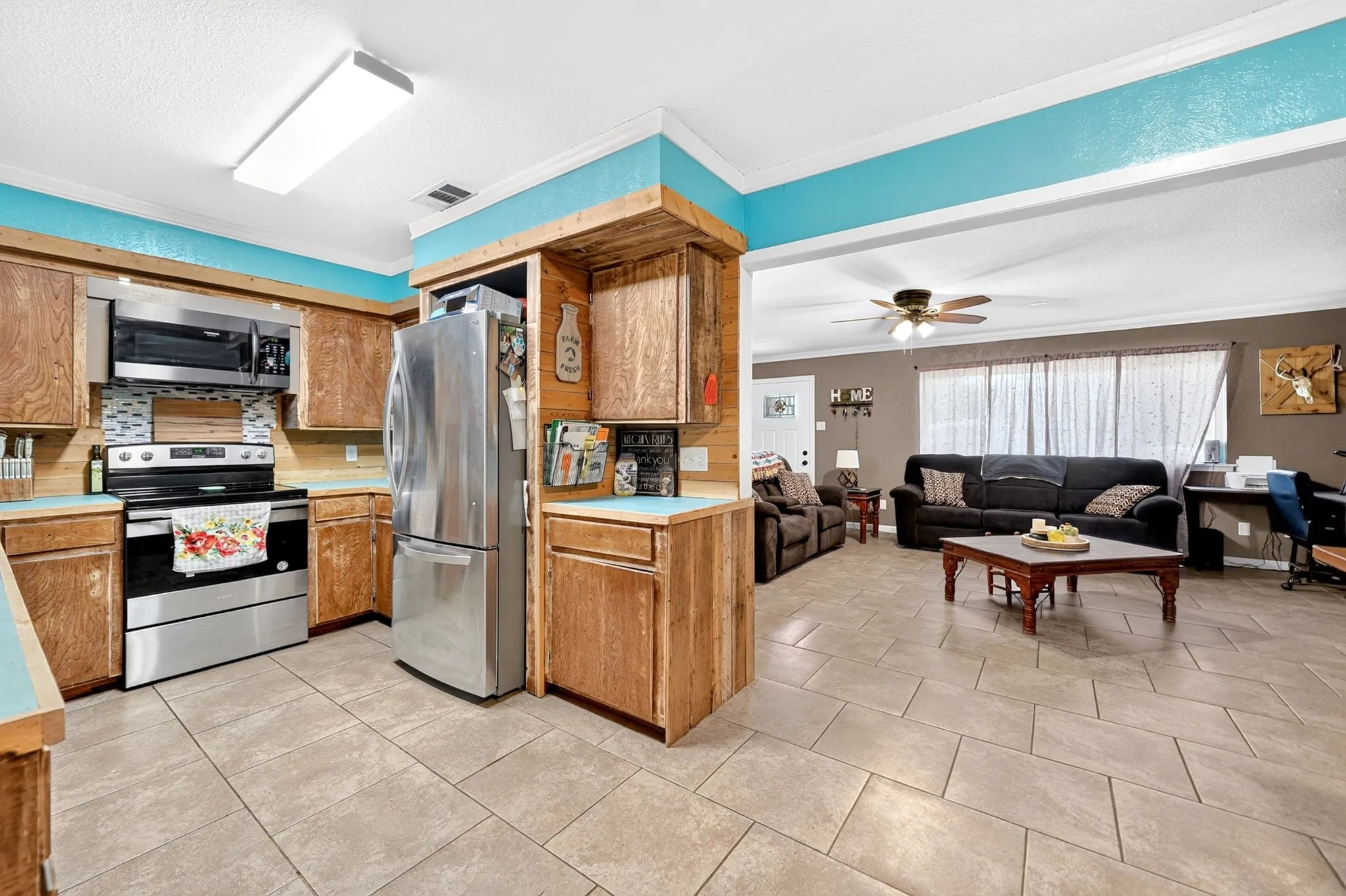 Kitchen featuring wood cabinetry, stainless steel appliances, and a tile backsplash