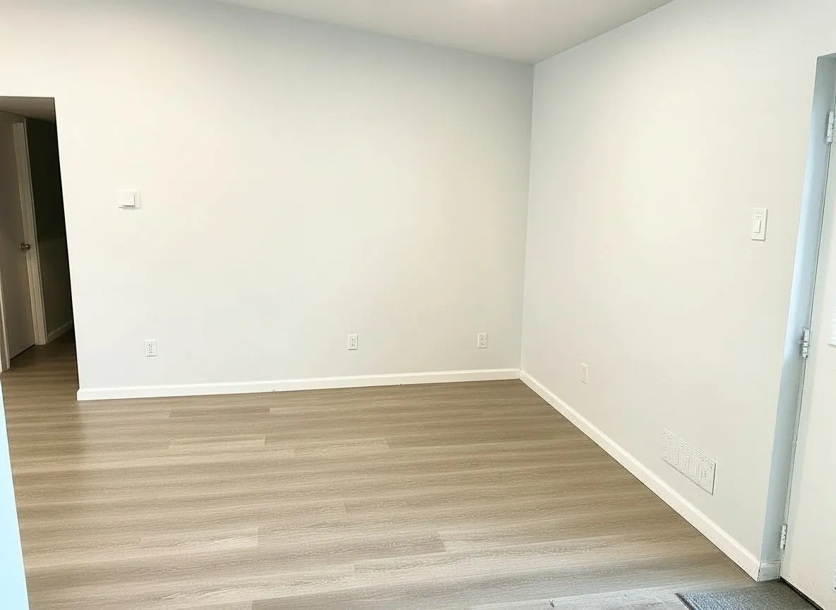 Light wood-finish flooring, white walls, and white trim