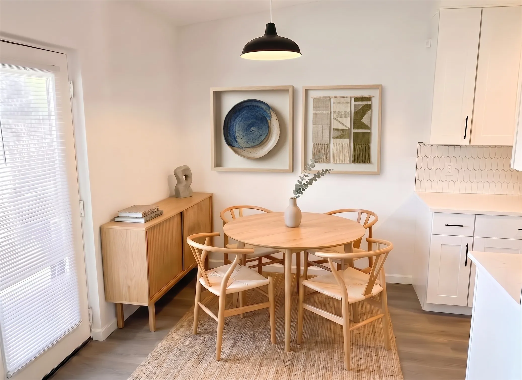 Recessed wall cabinetry, light wood-finish flooring, white tiled backsplash, and pendant lighting