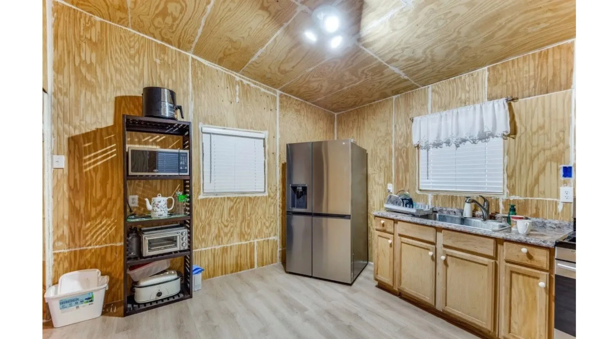 Wood-finish wall and ceiling panels, recessed lighting, and wood-finish flooring