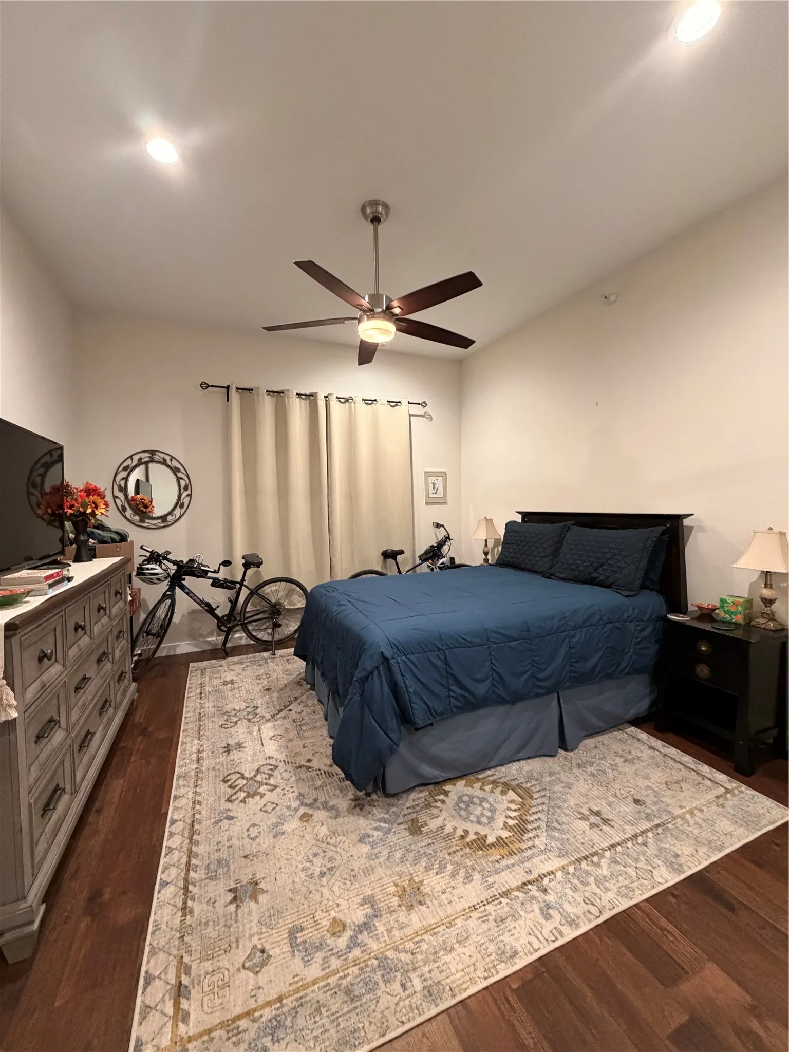 Recessed lighting, wood-finish flooring, and a ceiling fan with integrated lighting