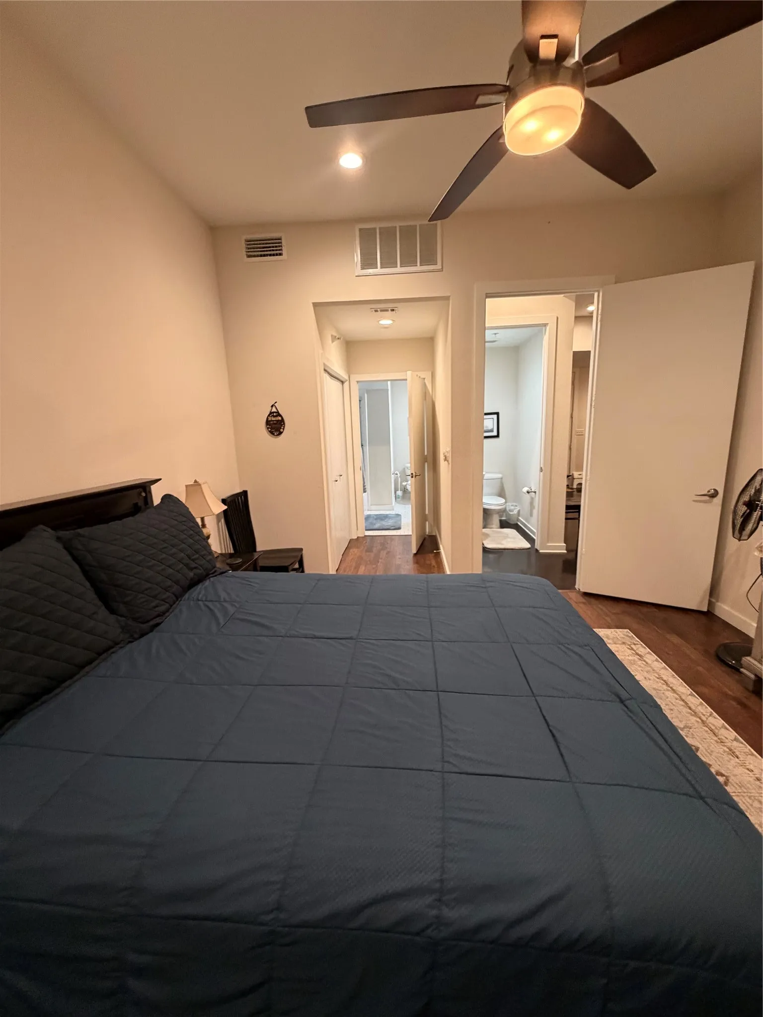 Recessed lighting, wood-finish flooring, and a ceiling fan with integrated lighting
