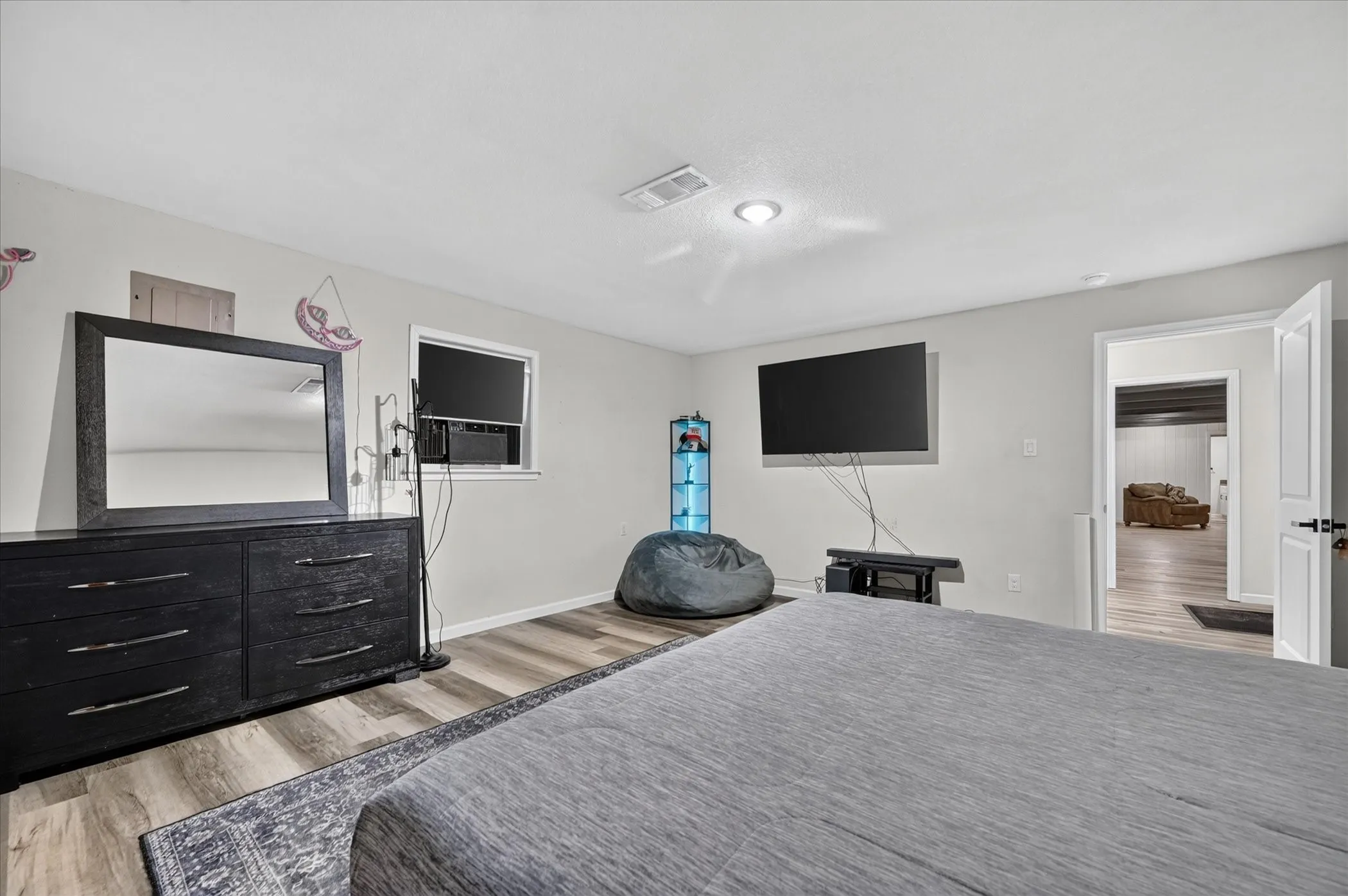 Recessed lighting, wood-finish flooring, and white interior doors