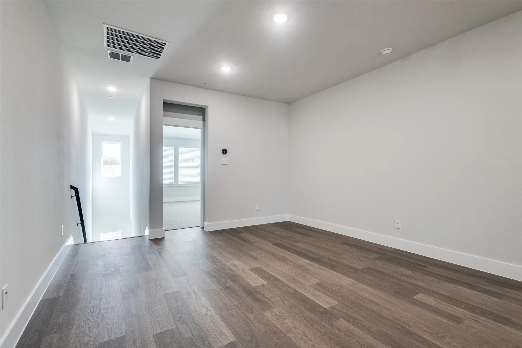 Unfurnished room with dark wood-type flooring