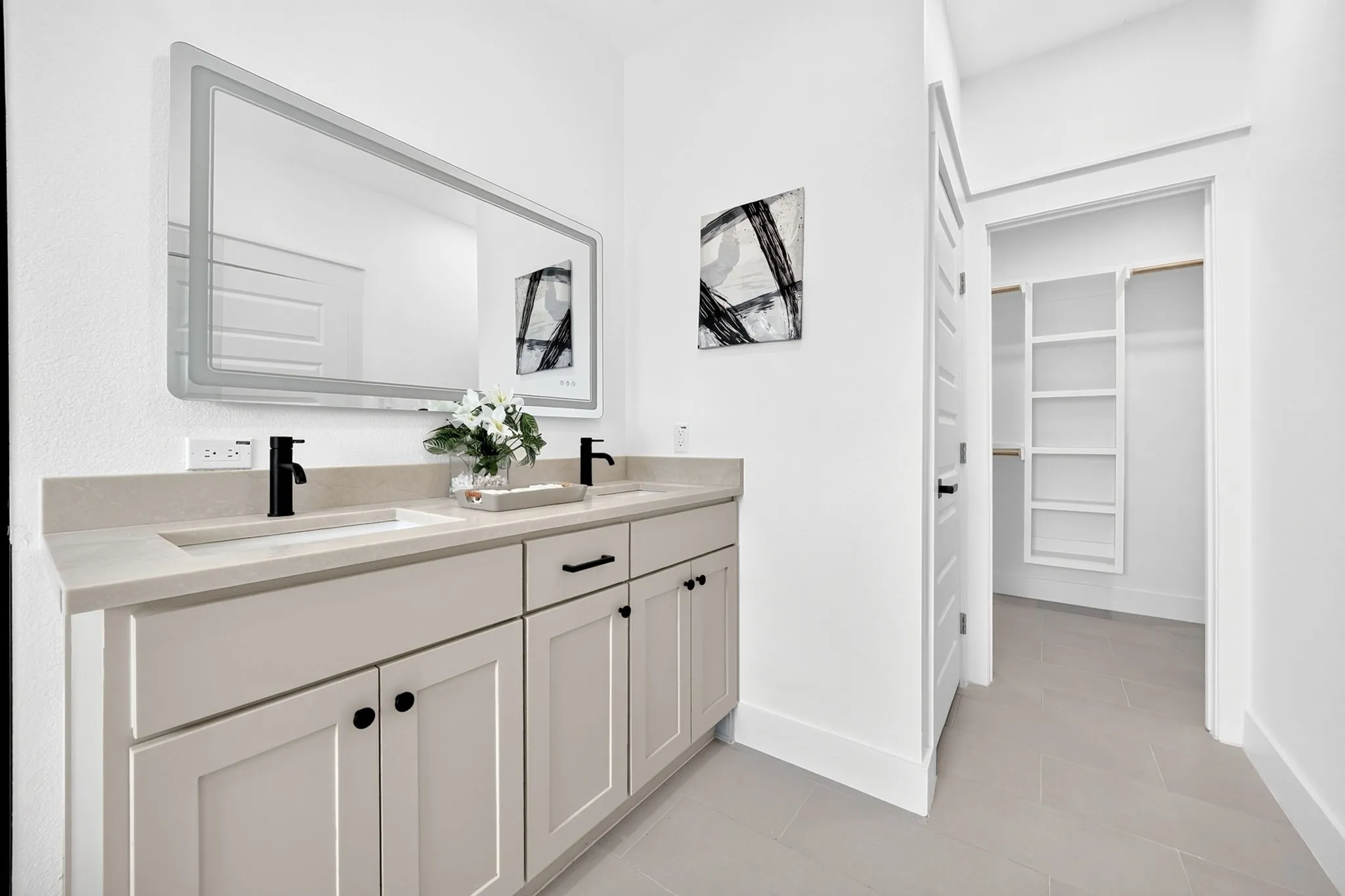 Double vanity with integrated sinks, light-toned countertop, and matte black fixtures