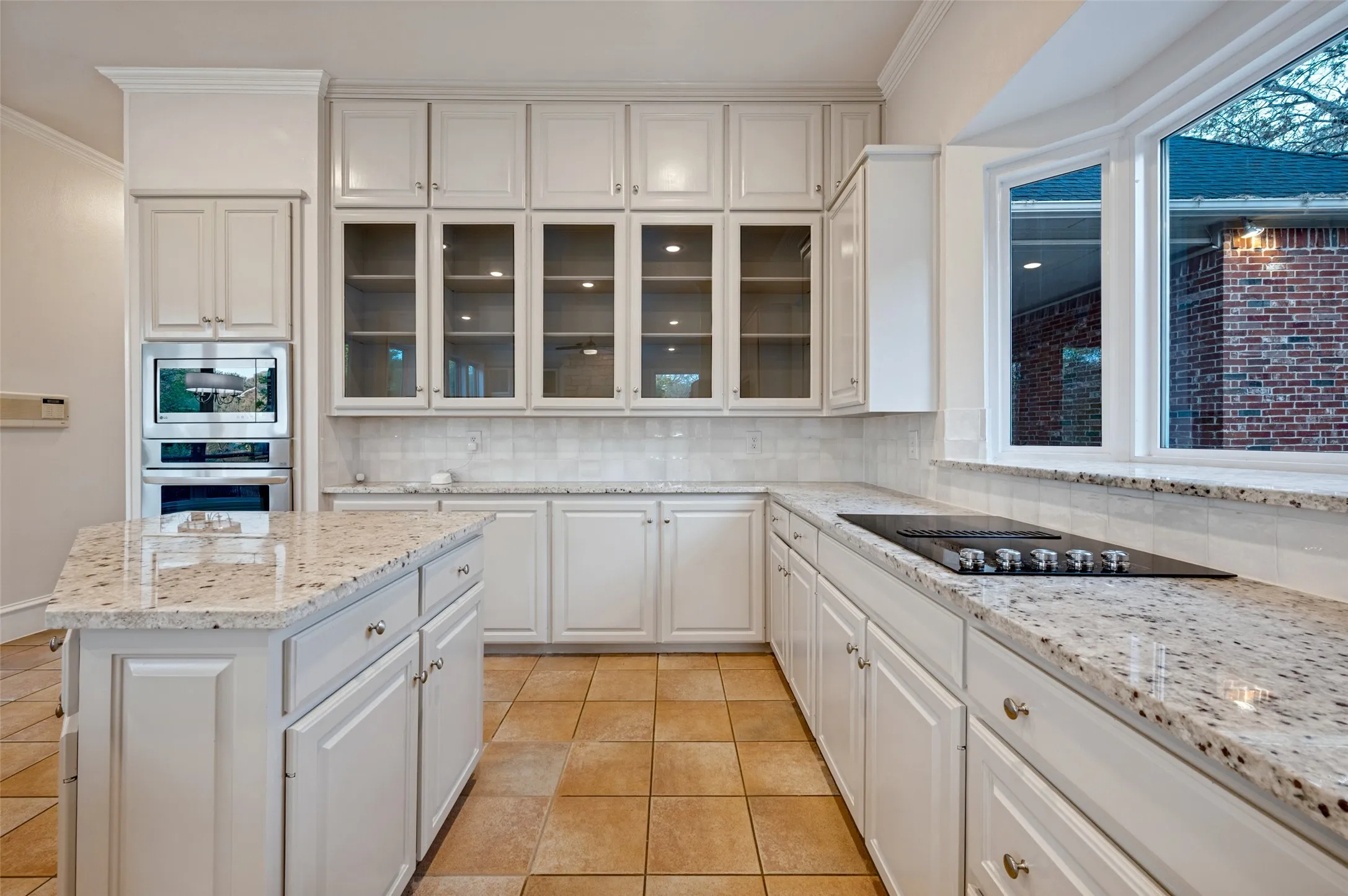 All new granite installed in Colonial White, newly painted cabinetry, & new kitchen sink and faucet