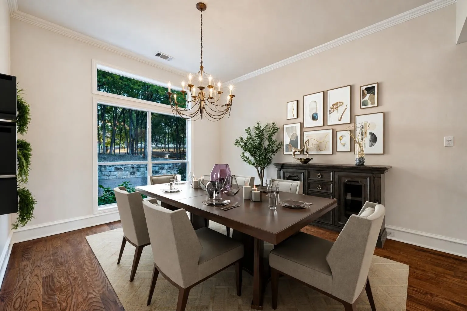 Virtually staged formal dining room with a darling modern chandelier and featuring real hardwood floors