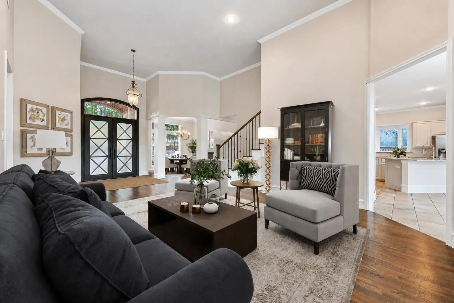Virtually staged formal living room showcasing hardwood flooring and the fresh paint featured throughout the entire house, as well as a new and updated entry door!