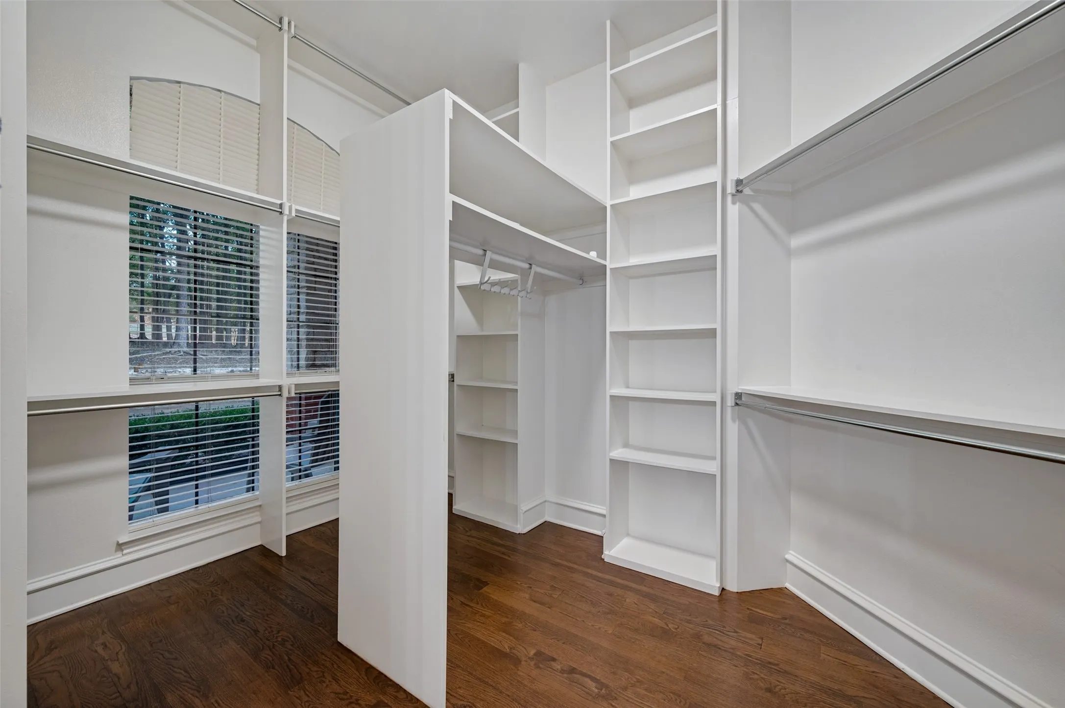Walk in closet filled with convenient custom built in cabinetry