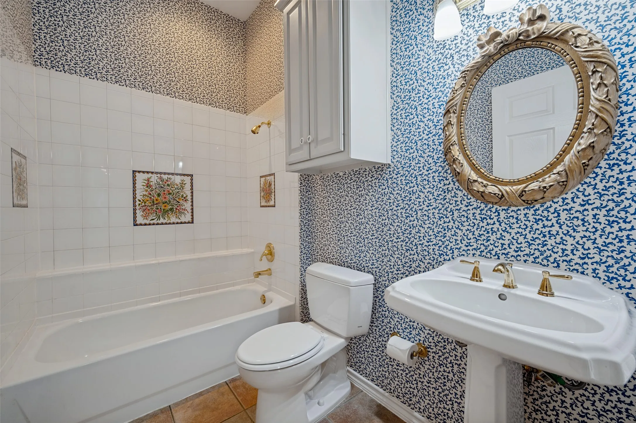 Downstairs full guest bathroom beside the guest bedroom with darling vintage tile from the original owner's honeymoon trip