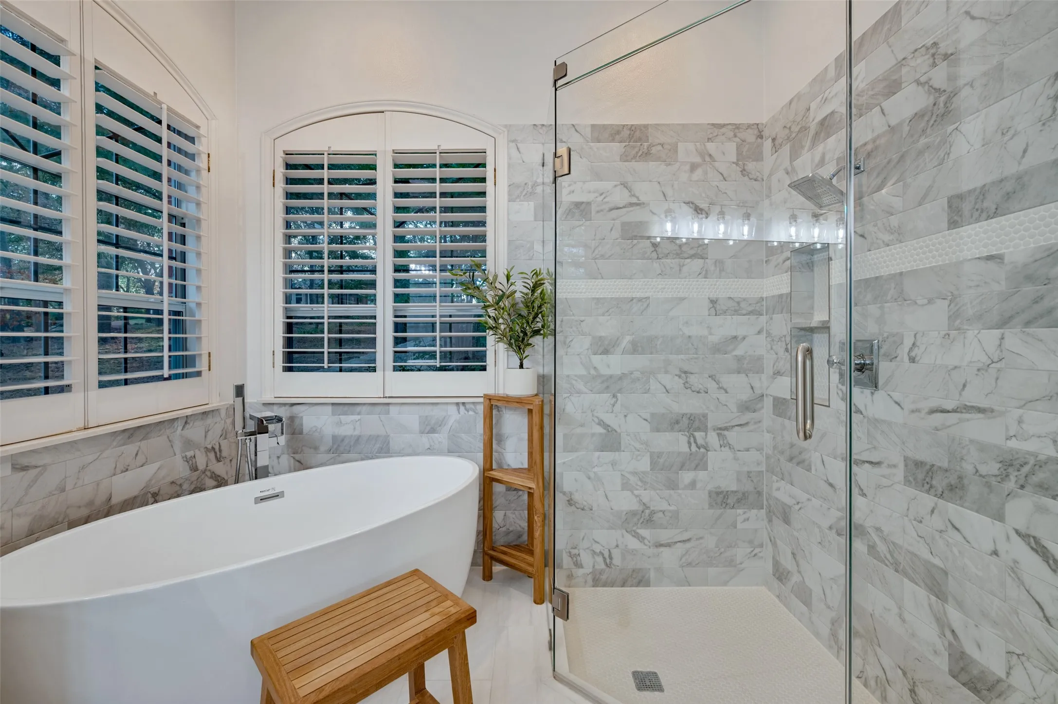 Ensuite primary bath recently completely remodeled with all new granite installed in Colonial White, matching the kitchen, dual vanities, a deep freestanding soaking tub, and an oversized walk-in shower