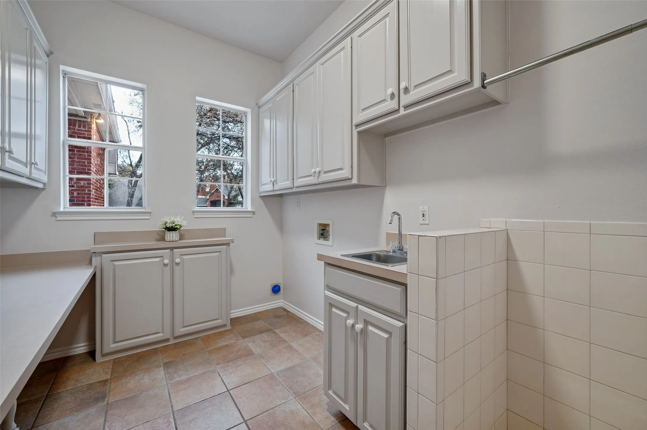 Separate laundry room backs up to kitchen and offers additional pantry storage, room for a refrigerator, a utility sink, and a surprise laundry shoot from upstairs!