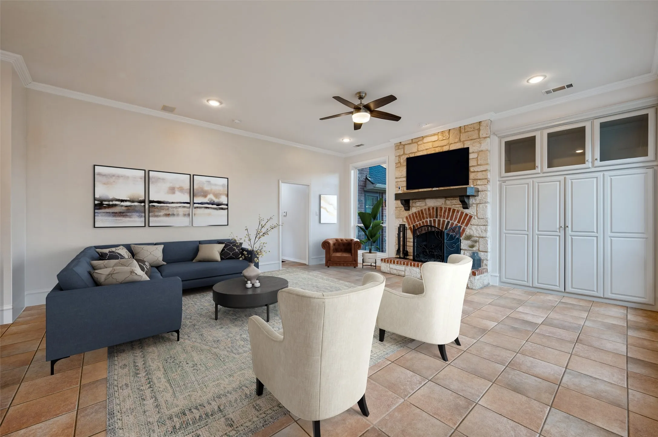 Virtually staged family room showcasing a wood-burning fireplace, new windows along the back of the home, and new light fixtures. The entire home has also been freshly painted