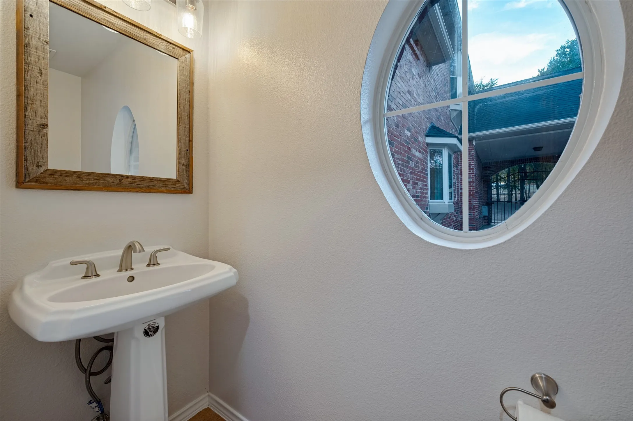 Half bathroom downstairs by the garage and across from the workout room