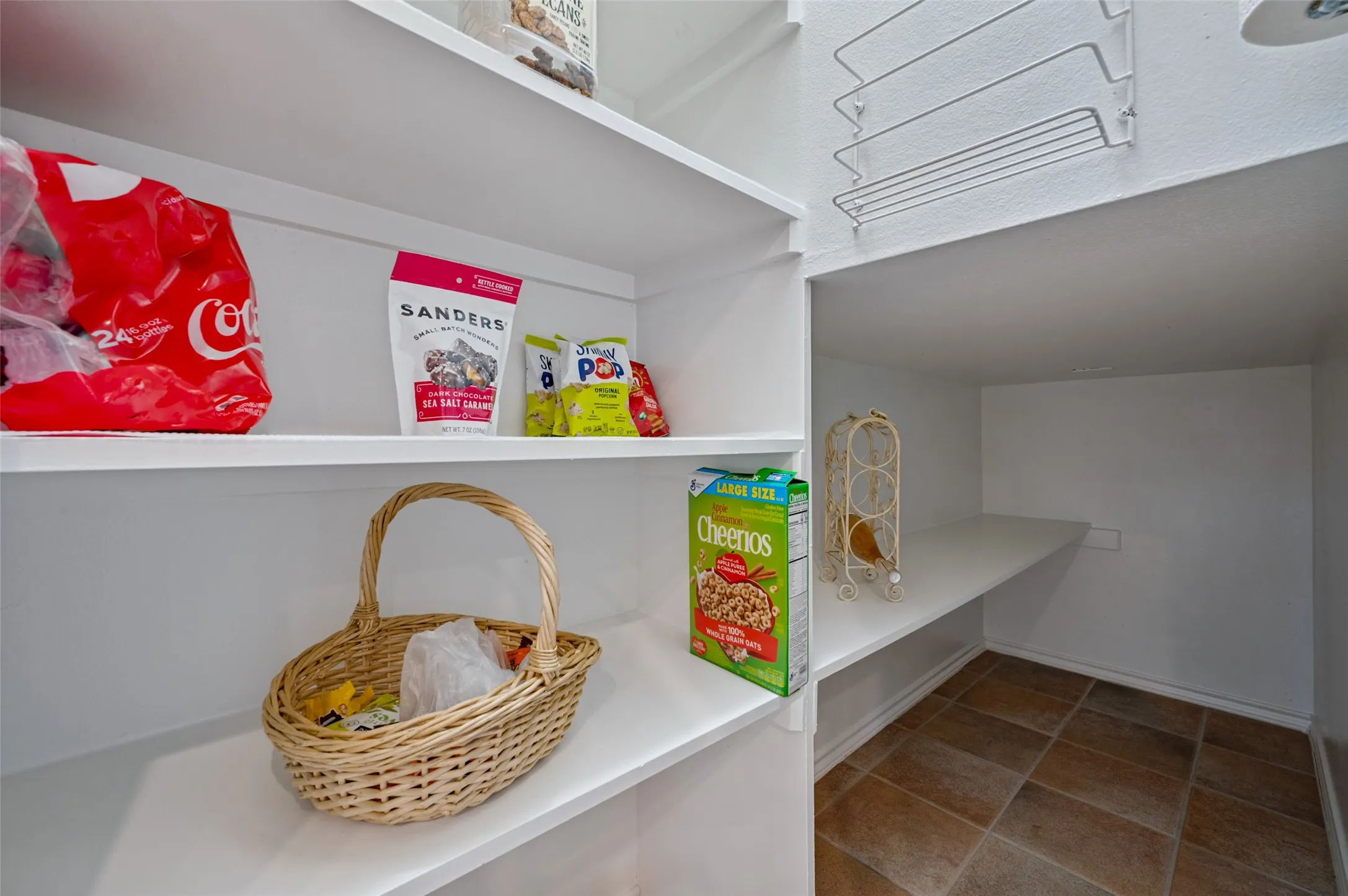 Walk in pantry that extends under the staircase for more storage and can double as a storm room