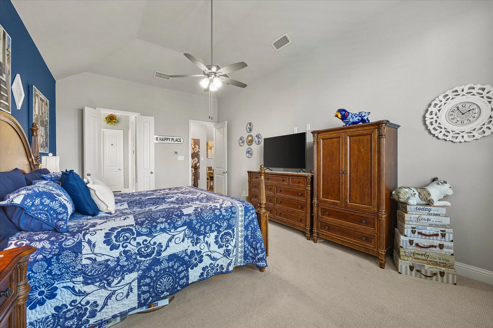 Vaulted ceiling with ceiling fan, wall-to-wall carpeting, and multiple interior doors