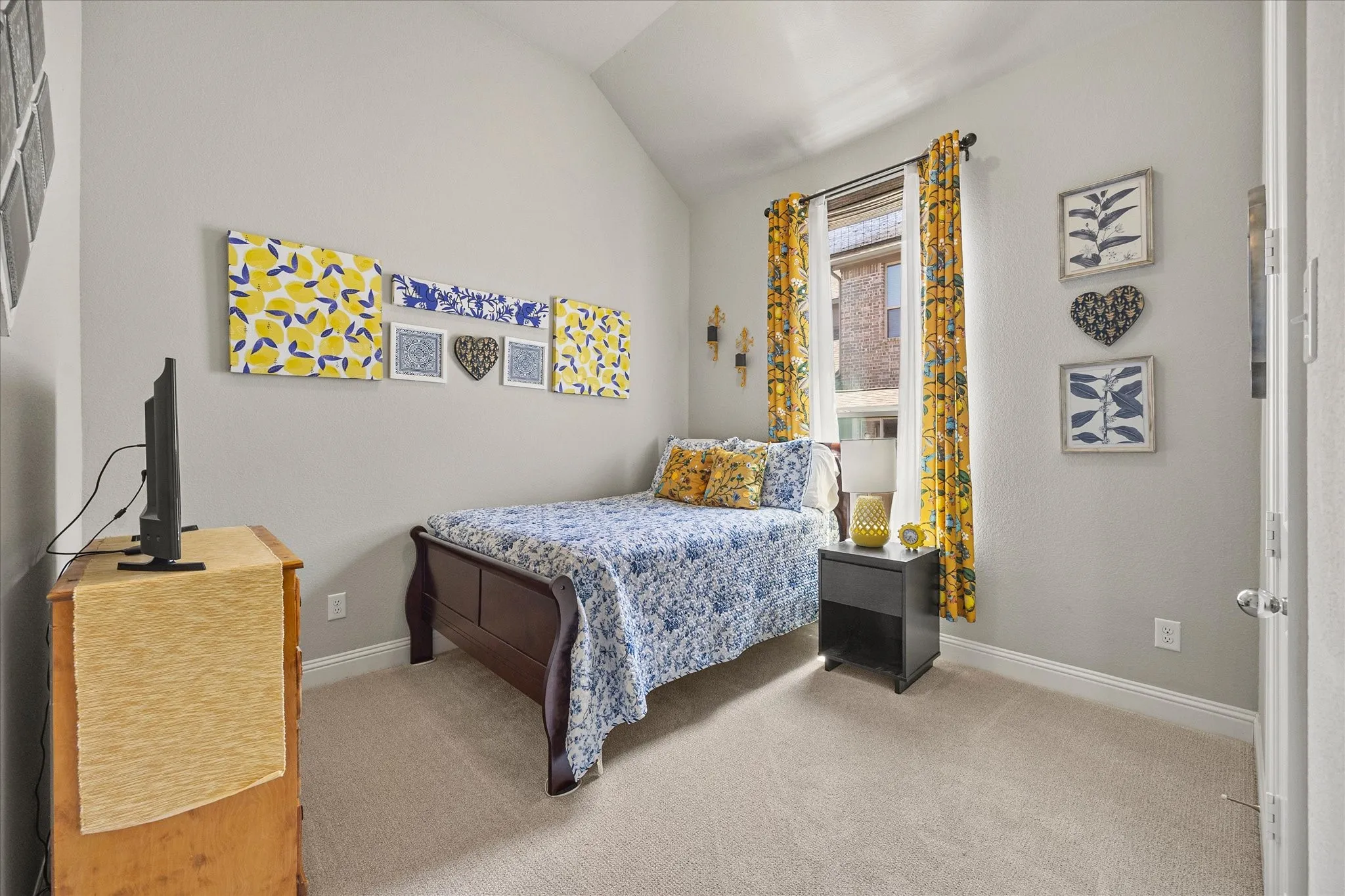 Window with ample natural light, vaulted ceiling, and neutral carpeting