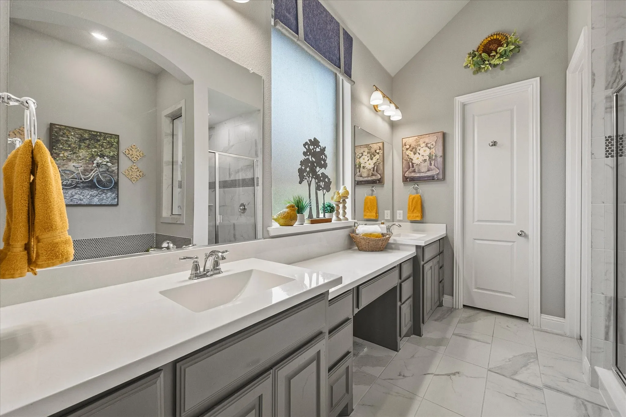 Dual vanities with white countertops and gray cabinetry