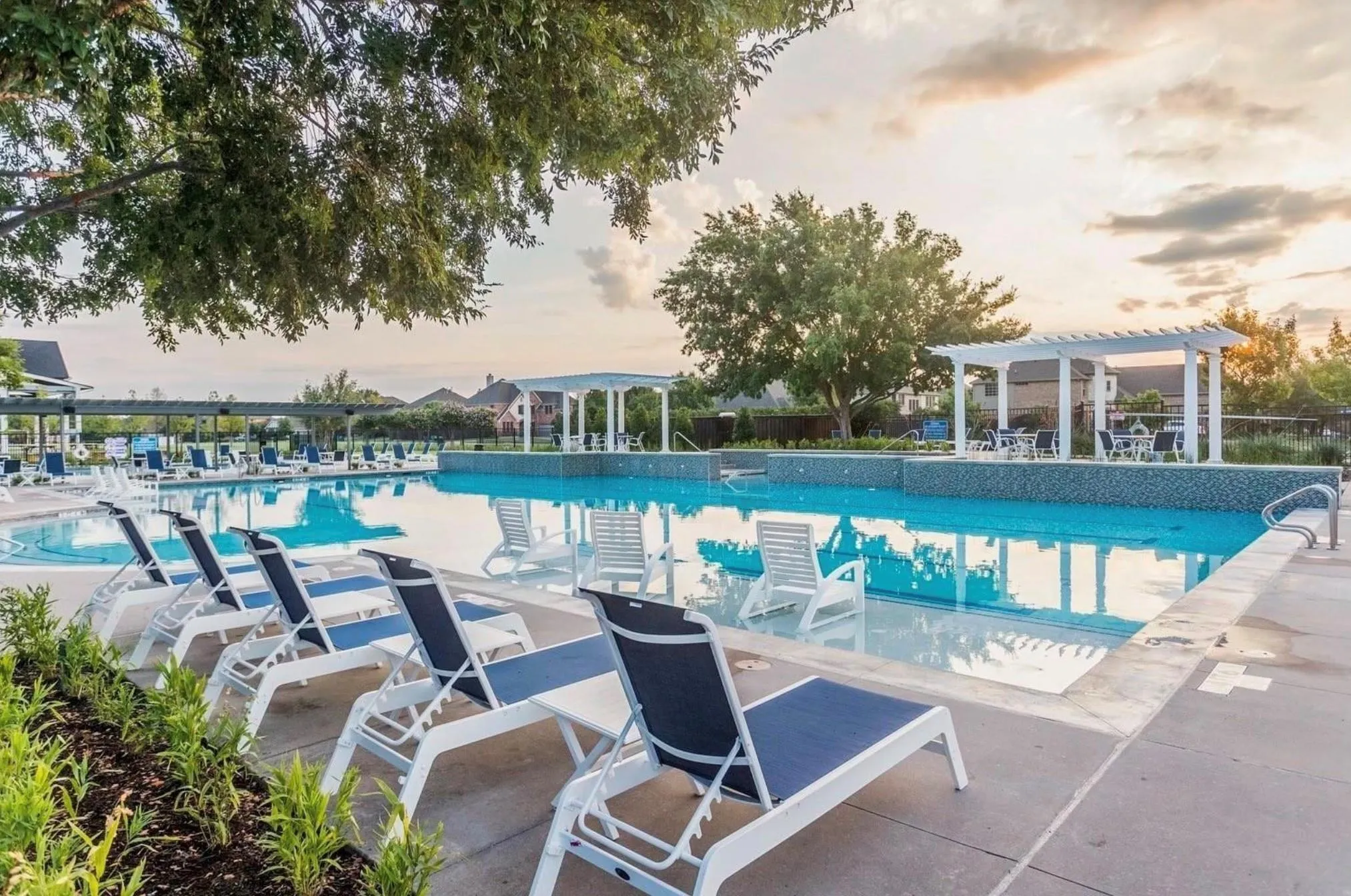 Expansive swimming pool with concrete decking