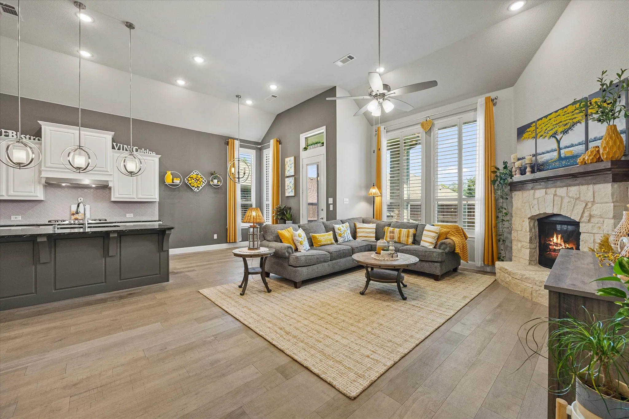 Vaulted ceilings complemented by recessed lighting and a ceiling fan