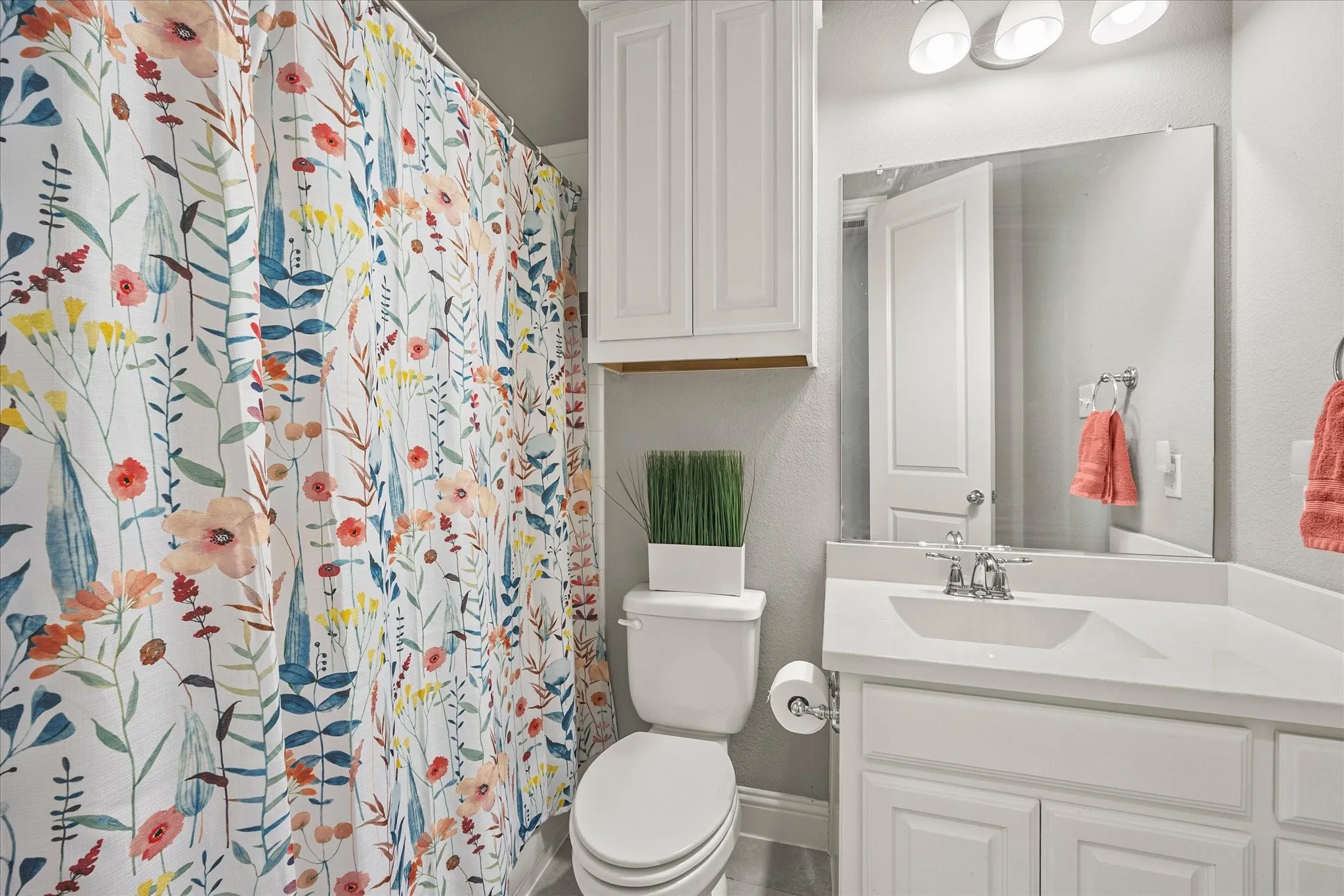 White vanity with an integrated sink and chrome faucet
