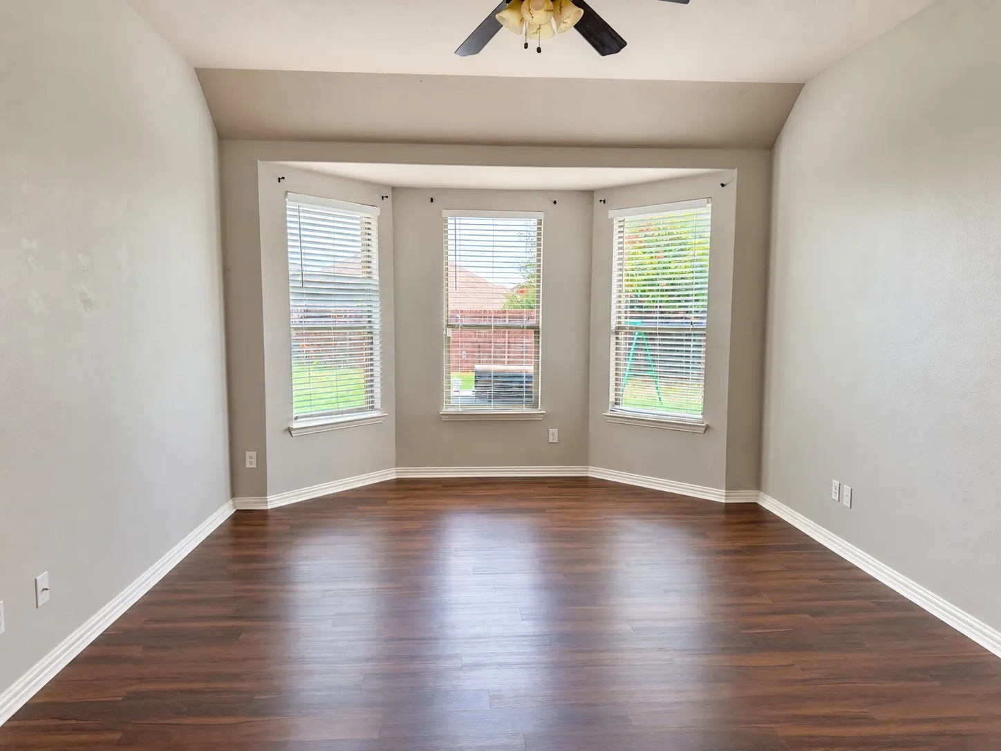 Primary bedroom with bay windows.
