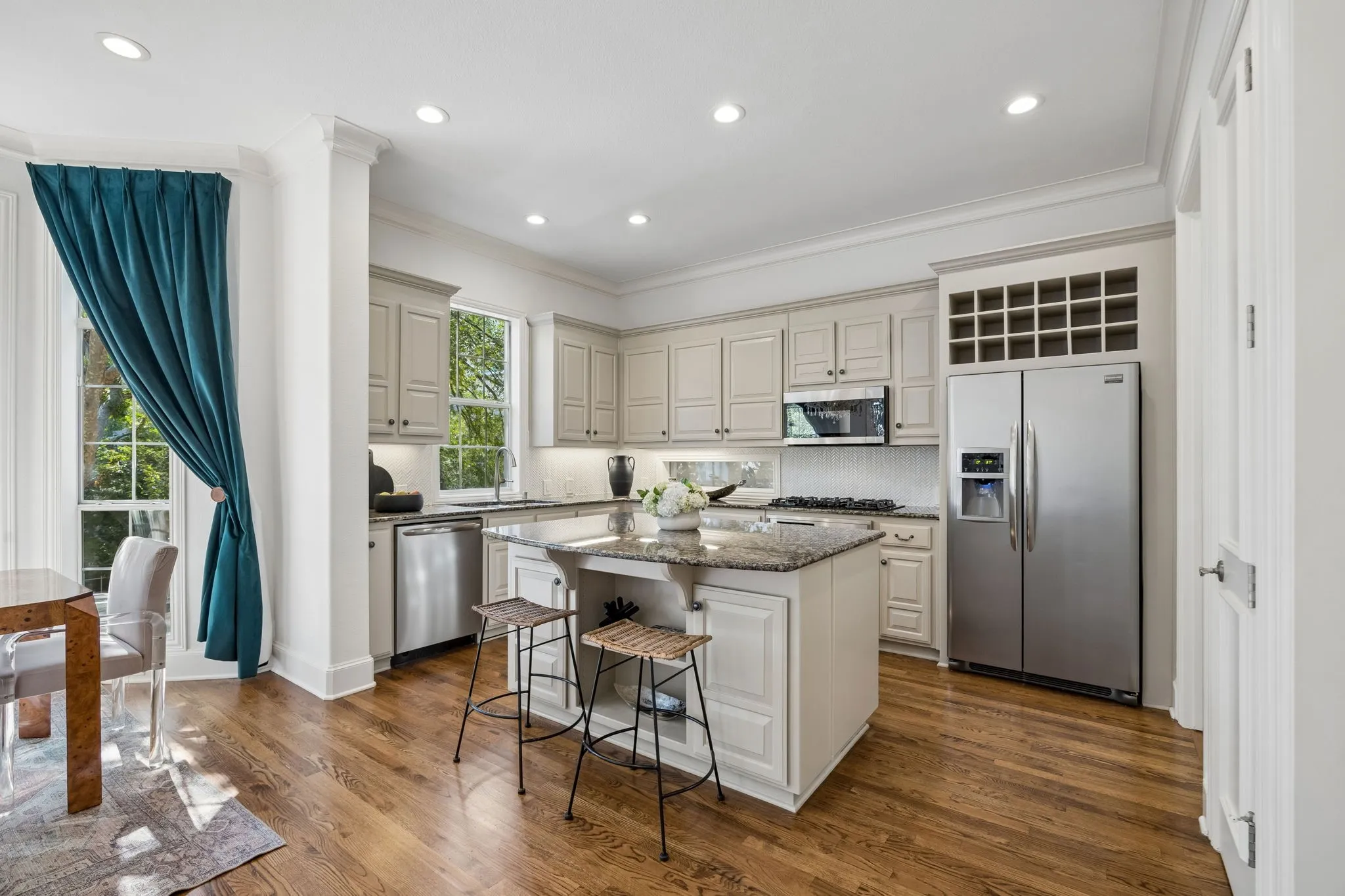 Spacious kitchen with island seating for casual dining and entertaining, plus a gas range for the home chef.