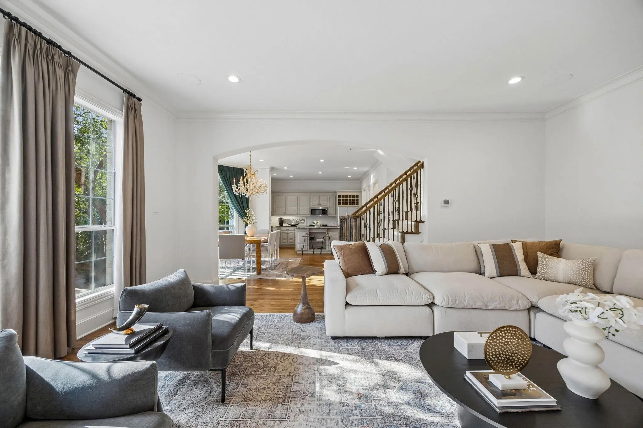 Open floor plan on the main level with high ceilings, hardwoods and floor-to-ceiling windows for natural light.
