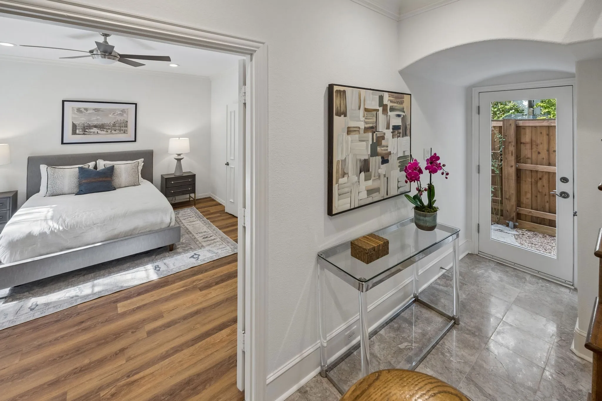 Generous 1st floor ensuite bedroom off the foyer with a walk-in closet. Exterior back door leads to a fenced backyard.