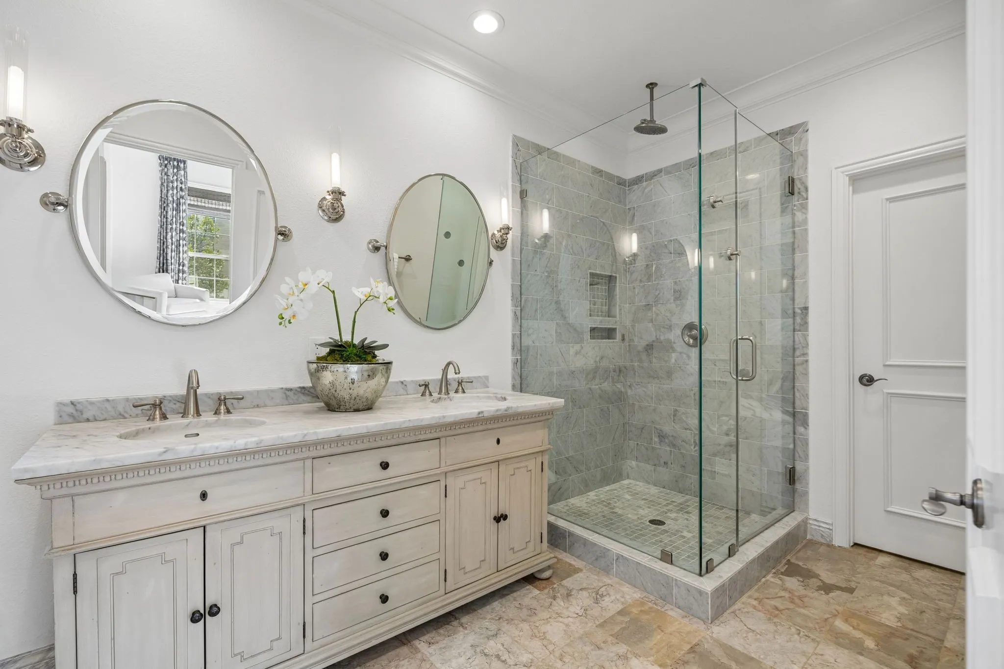 Marble, frameless glass shower with a rainfall showerhead. Separate toilet closet.