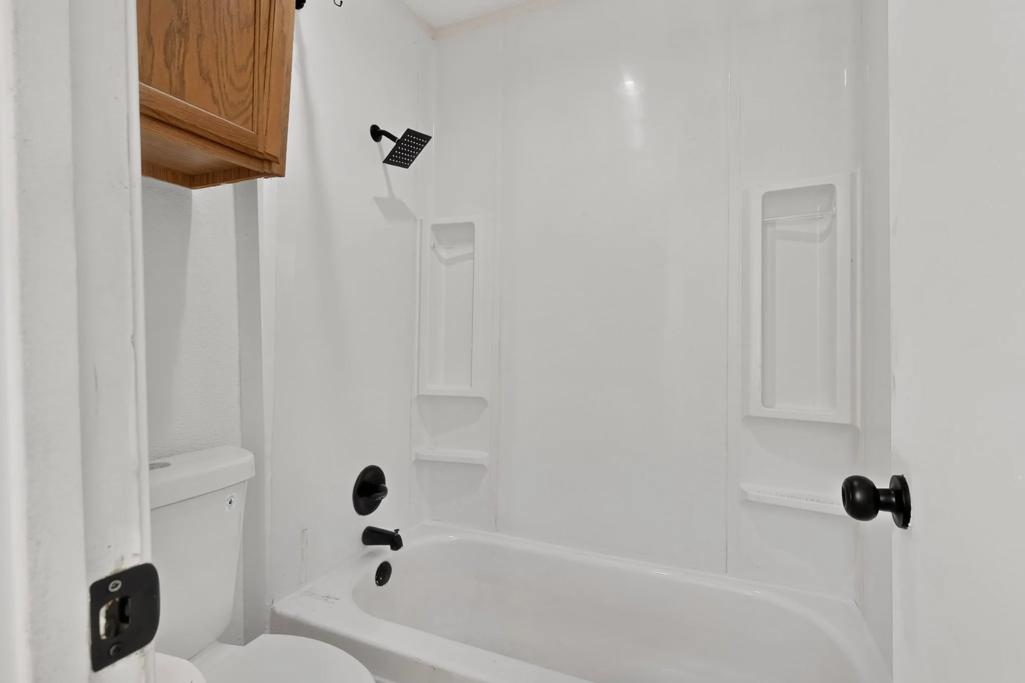 White shower and tub combination with matte black fixtures