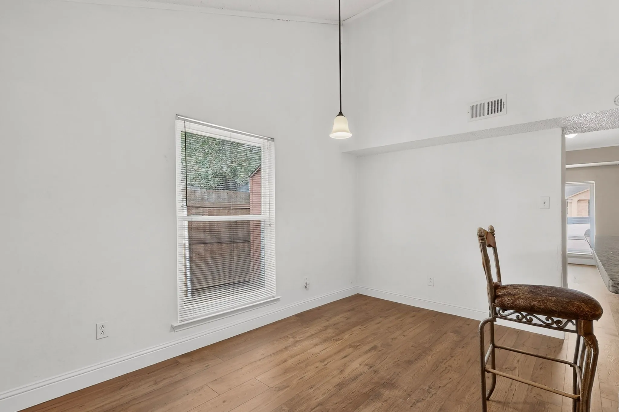 Vaulted ceiling featuring a pendant light fixture