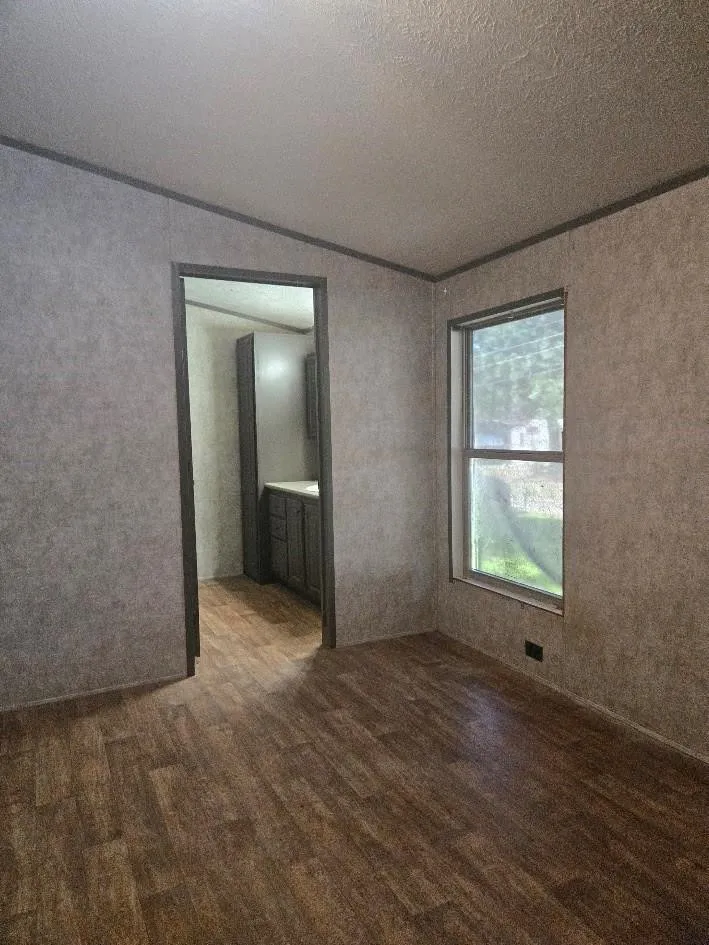 Wood-finish flooring with a window offering natural illumination