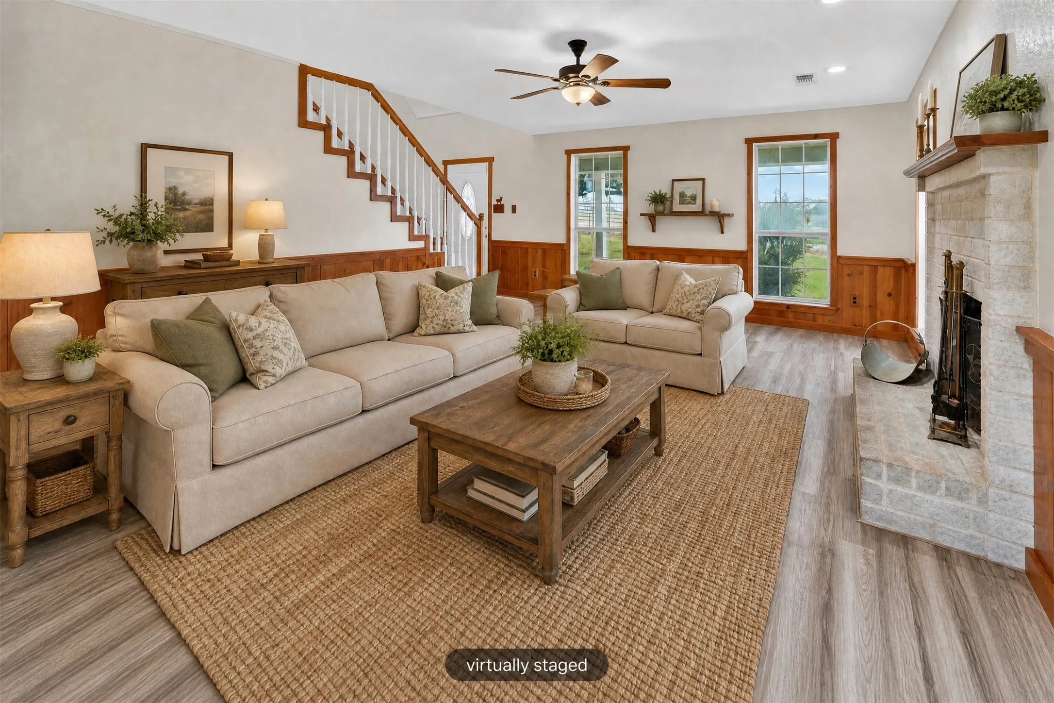 Living space featuring wood-finish flooring, a stone fireplace, wood paneling, and a staircase with white risers and wood handrails