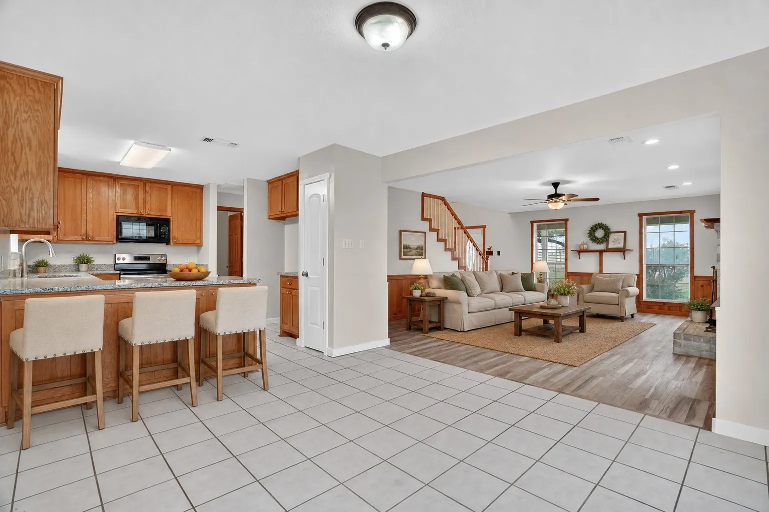 Kitchen featuring granite countertops, wood cabinetry, and stainless steel appliances