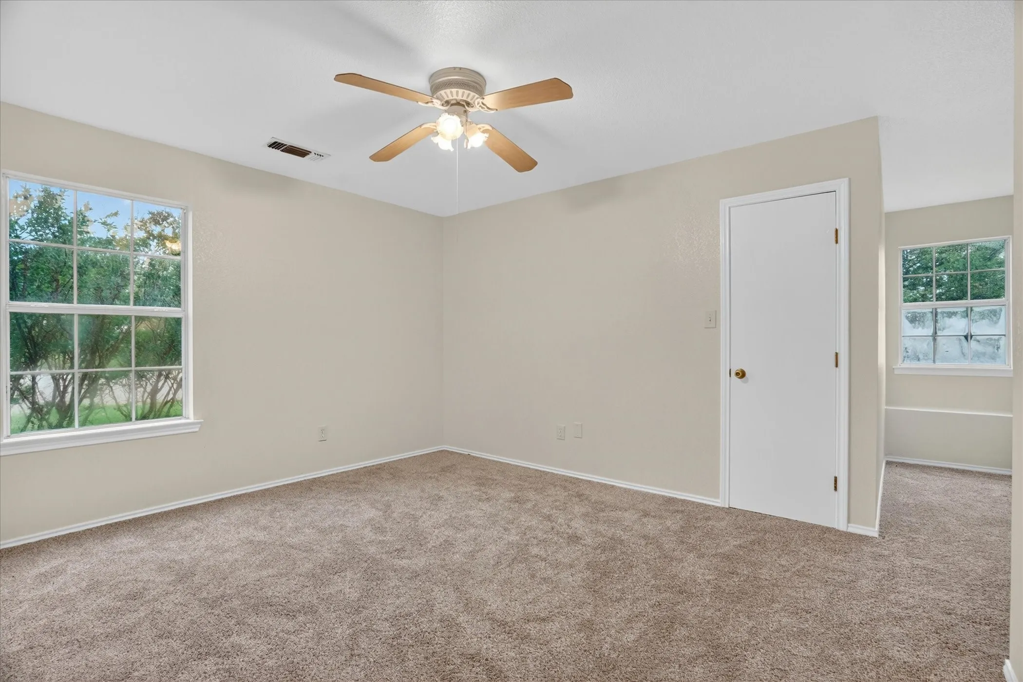 Neutral carpeted flooring with light-toned walls
