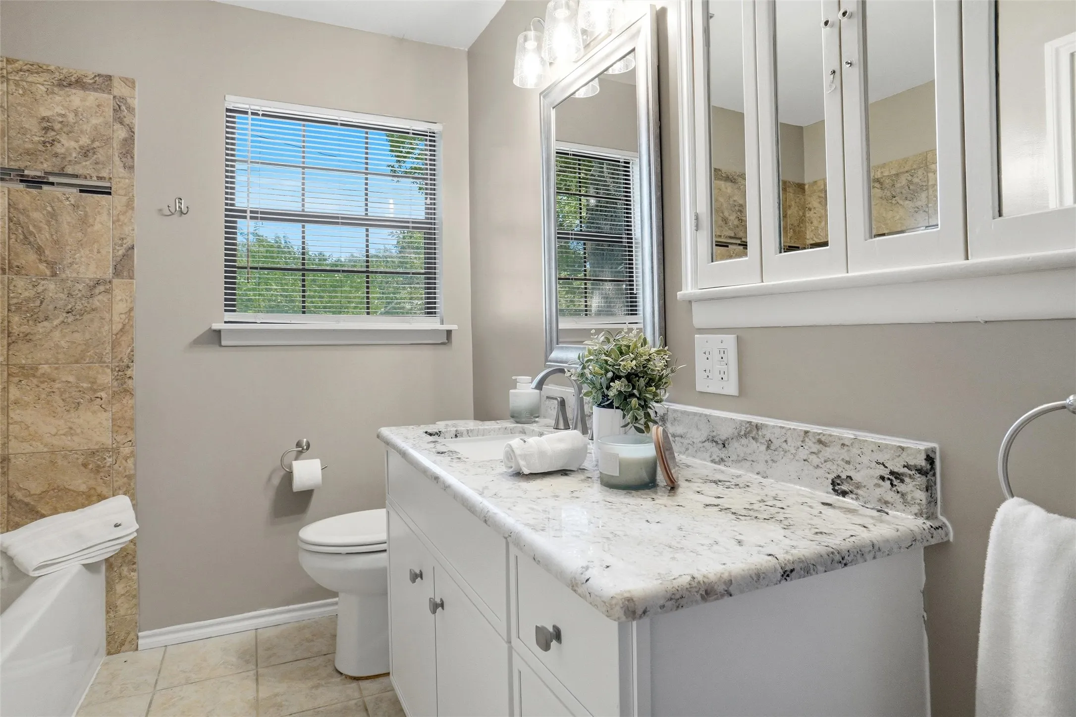 Updated 2nd Bath overlooks backyard.
New Vanity w Satin Nickel Hardware & restored mirrored Medicine cabinet.